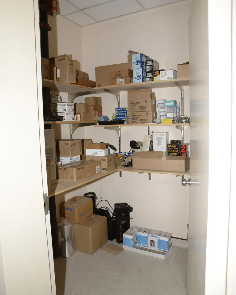 Neatly arranged closet shelves with folded clothes and baskets