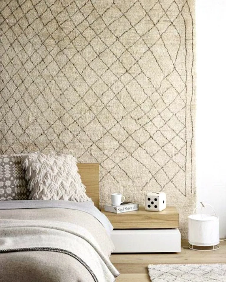11 Cute Bedding Ideas That Make Your Bedroom Feel Like a Dream 12 Bed layered with a boho-style quilt and textured pillows