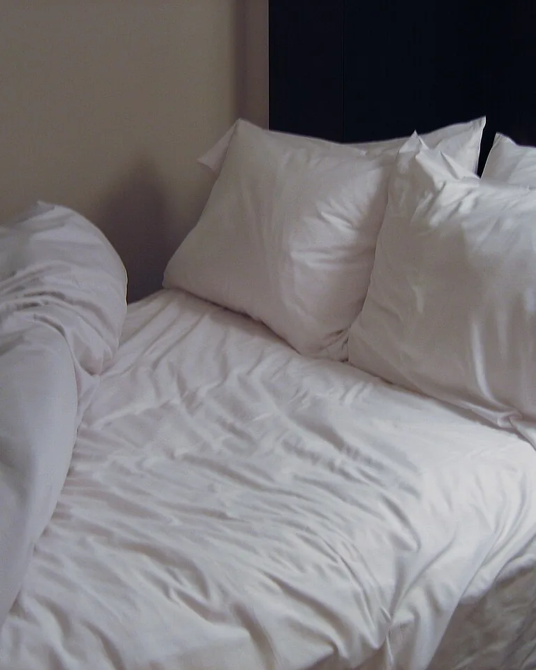 12 Married Couple Bedroom Ideas That Feel Personal and Balanced 6 Close-up of layered bed linen and two duvets on a neatly made couple's bed