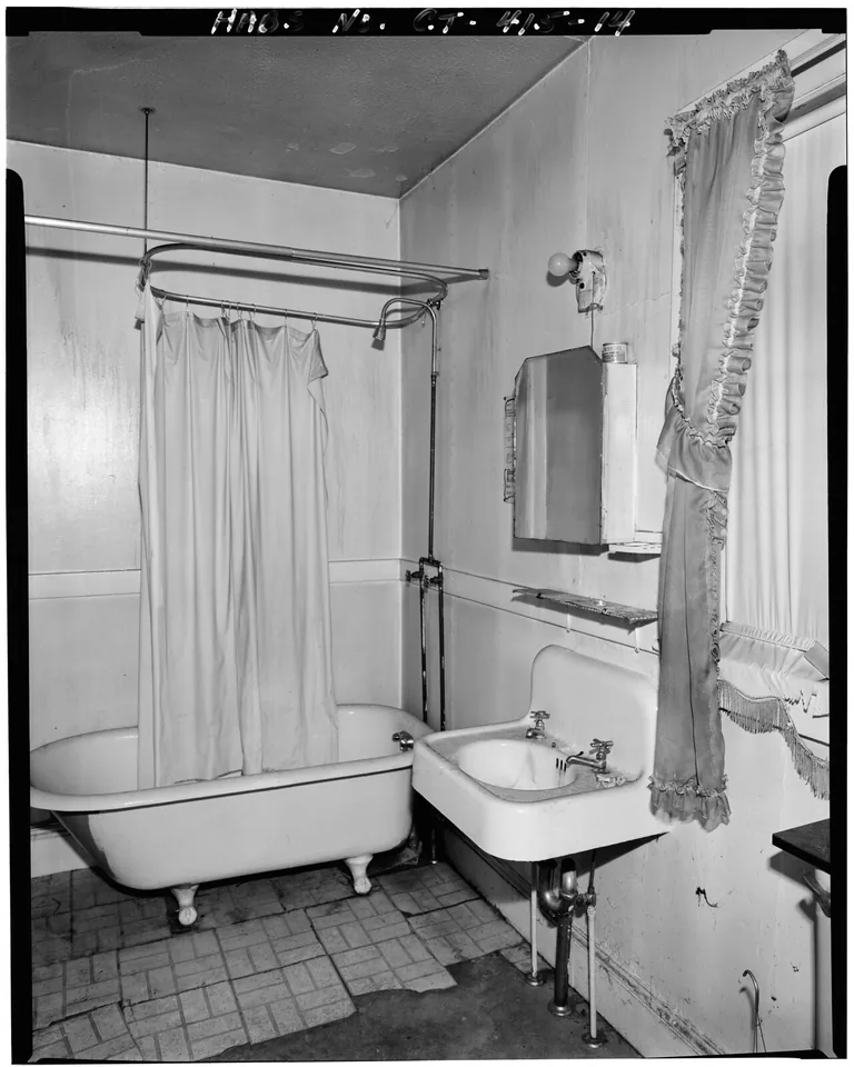 Freestanding bathtub in a beige bathroom