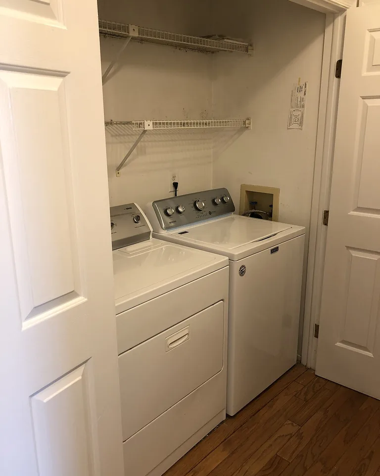 12 Stacked Laundry Room Ideas for Small Spaces That Make Every Inch Count 13 Small laundry closet with stacked appliances and shelves