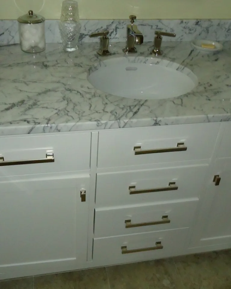 Classic beige bathroom vanity with polished brass fixtures