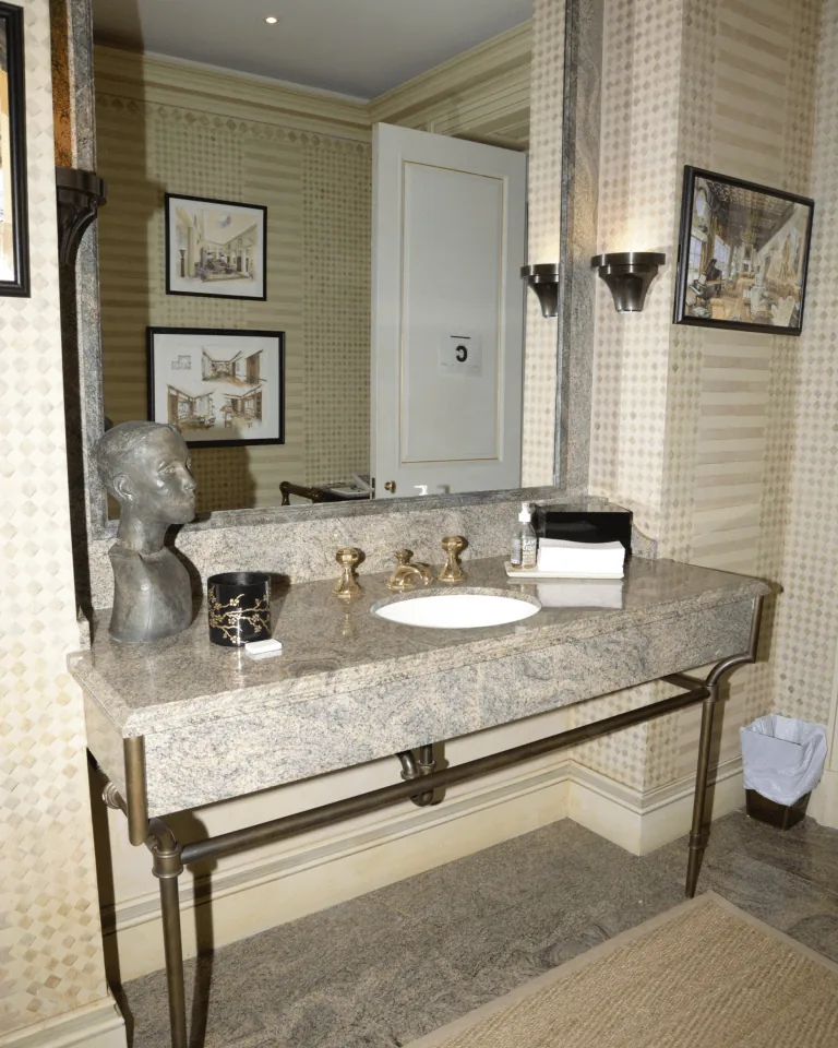 Beige marble bathroom vanity with brushed gold faucet