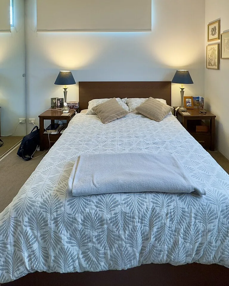 12 Married Couple Bedroom Ideas That Feel Personal and Balanced 12 Bedroom with warm neutral walls and a single deep accent color in the bedding
