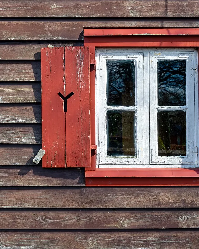 11 Window Painting Ideas for Beautiful Painted Glass (Easy DIY Guide) 15 Finished painted windows glowing warmly as daylight fades