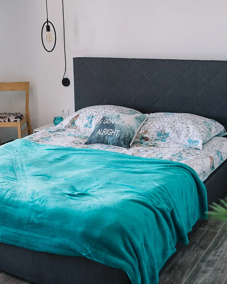 Cozy couples bedroom with warm neutral walls and soft bedding