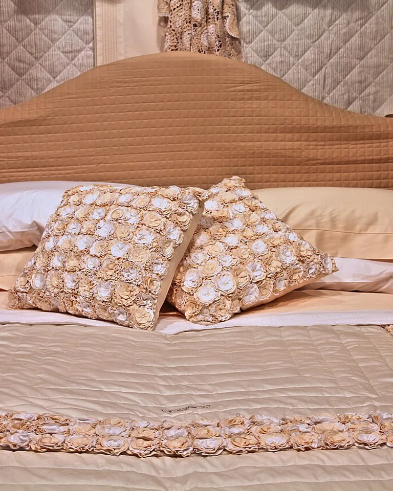 Bedroom with navy and emerald accent pillows on neutral bedding