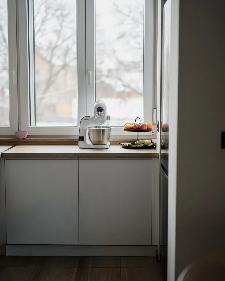 11 Kitchen Window Ideas That Make the Whole Kitchen Feel Brighter 1 Sunlit kitchen interior showing how window light shapes the room