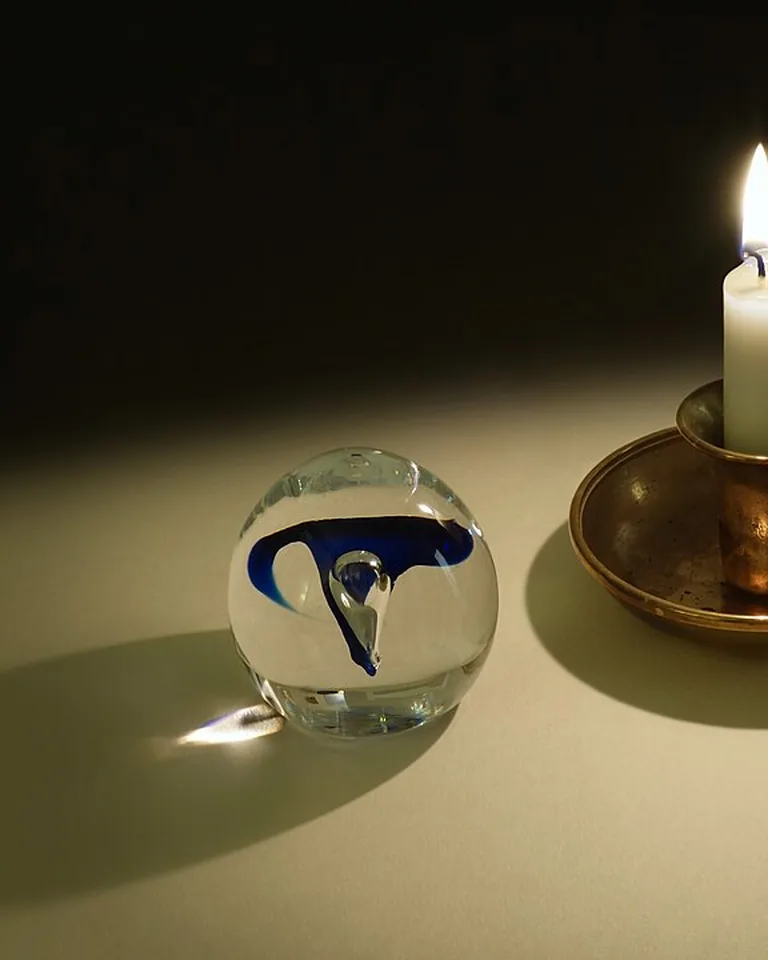 Cluster of taper candles and tea lights glowing on a Thanksgiving table runner