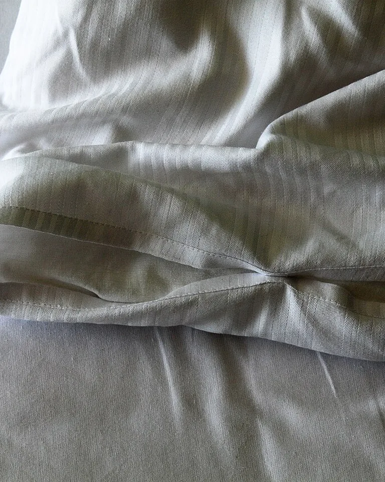 12 Moody Bedding Ideas That Make a Bedroom Feel Rich, Layered, and Intentional 4 Dark linen duvet cover in graphite on a styled bed