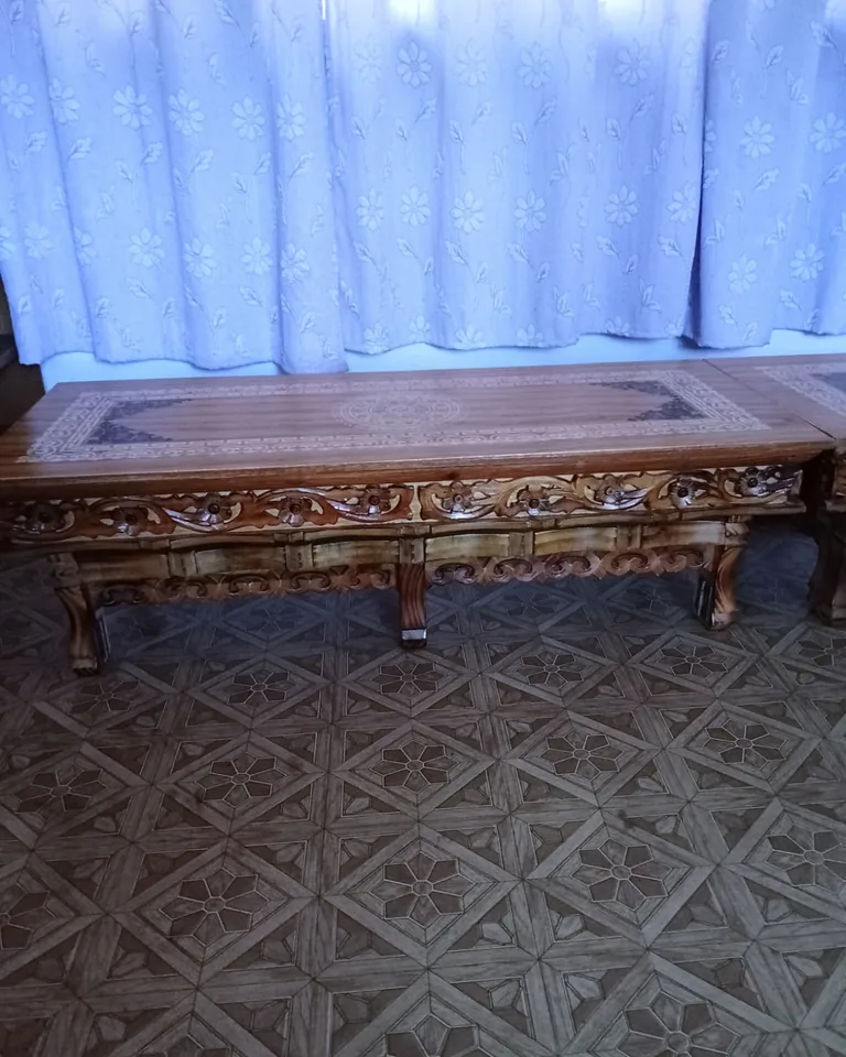Round wooden dining table styled for a small Thanksgiving dinner