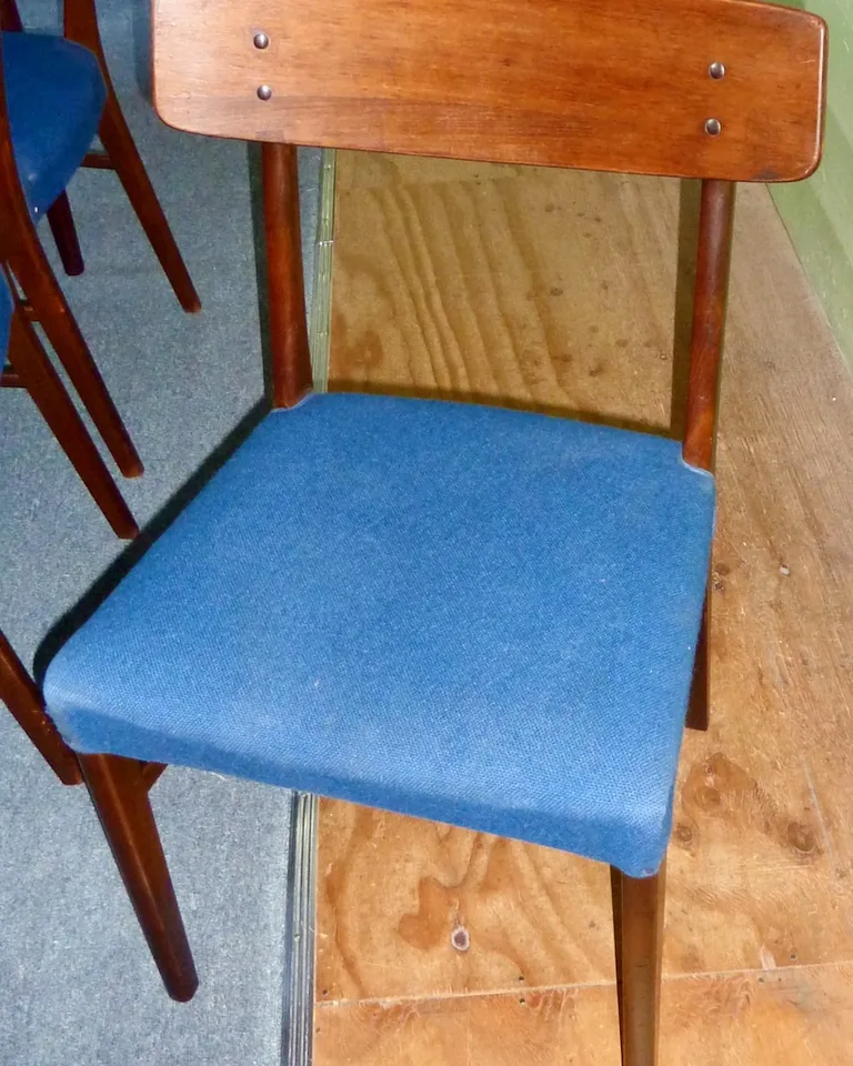Mix of bench, stools, and folding chairs arranged around a small dining table