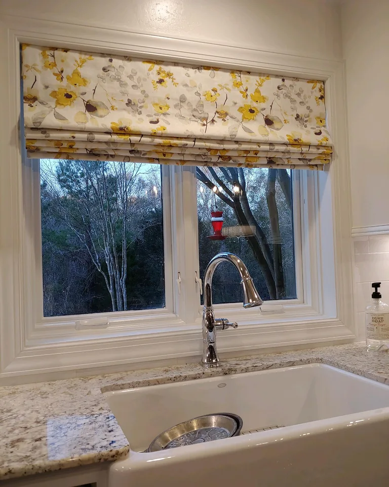 11 Kitchen Window Ideas That Make the Whole Kitchen Feel Brighter 7 Roman shade fitted on a kitchen window