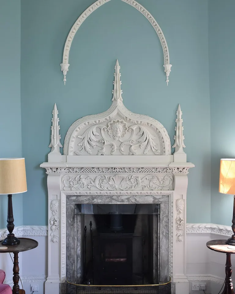 Living room with TV opposite the fireplace and window light