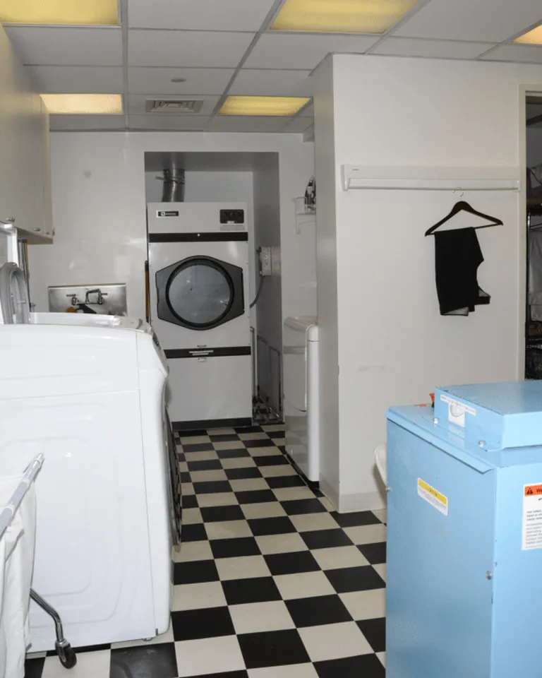 12 Apartment Laundry Room Ideas for Small Spaces That Deserve Better 3 Stacked washing machine and dryer maximizing a tiny laundry space