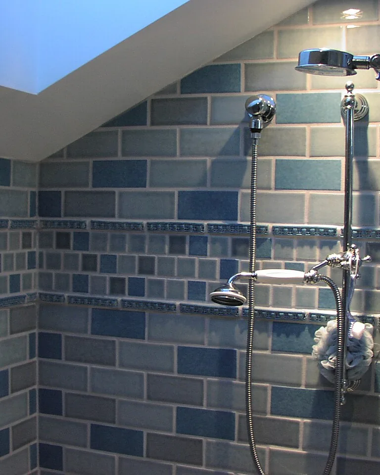 White subway tile shower with black fixtures in a farmhouse bathroom