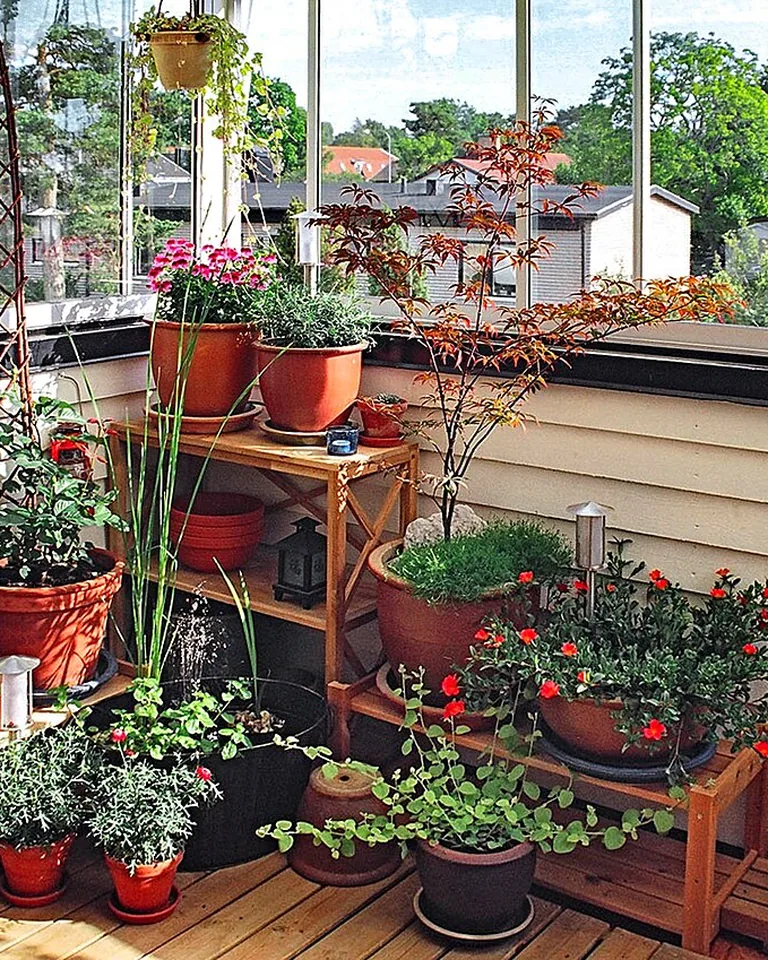 12 Small Balcony Color Palette Ideas That Make Tiny Outdoor Spaces Look Bigger 16 Small balcony filled with potted plants and greenery