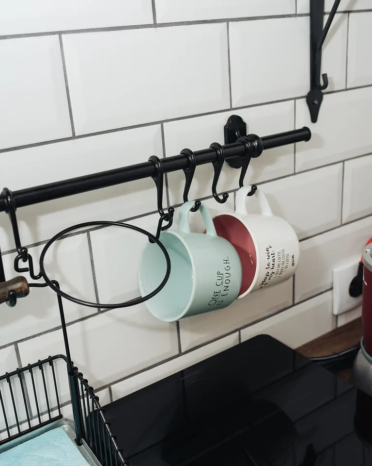 12 Bedroom Coffee Station Ideas That Bring the Morning Brew to Your Room 14 Collection of ceramic coffee mugs displayed on wooden wall shelves