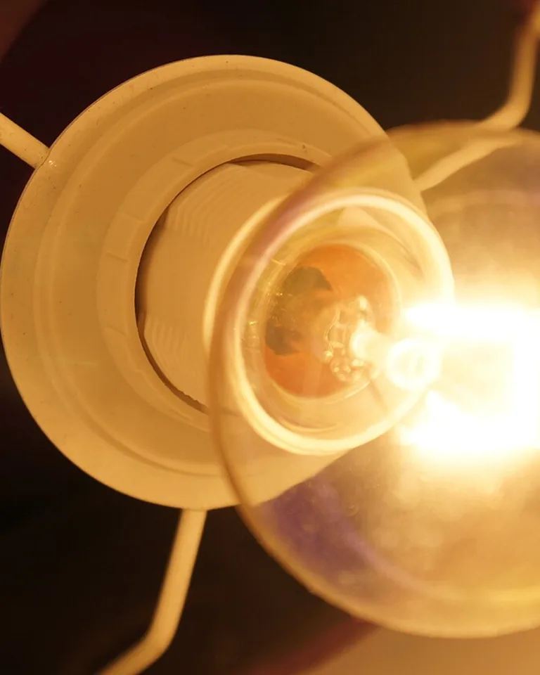 How to Brighten a Dark Room: 15 Fixes That Actually Work 9 Warm white LED light bulb glowing in a lamp