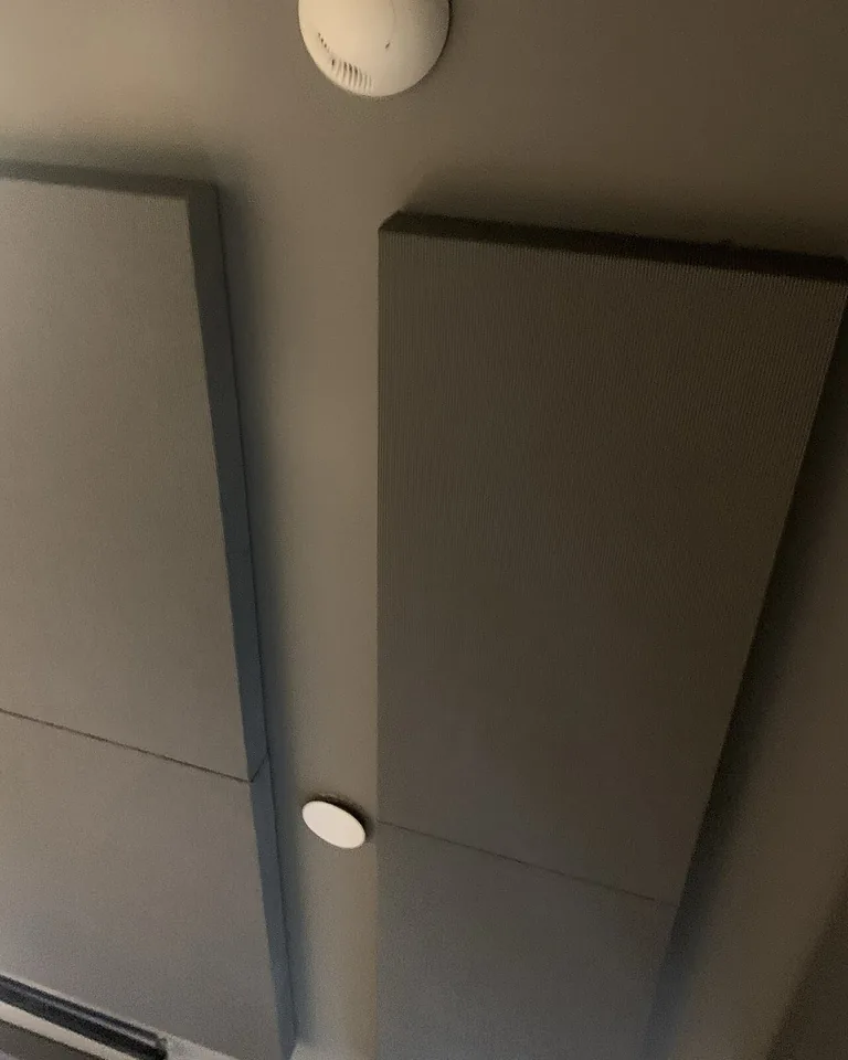 12 Black Gaming Setup Ideas That Look Sleek Without RGB Chaos 12 Black acoustic felt panels behind a gaming desk with thin LED lines