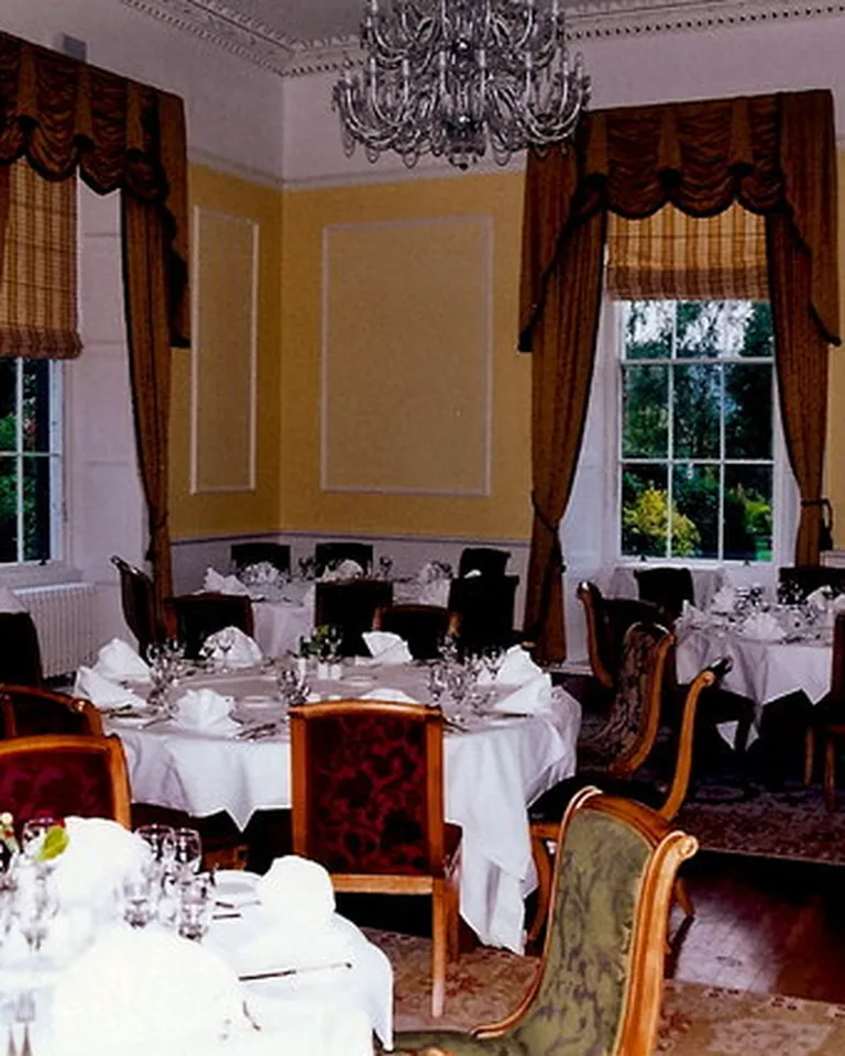 How to Make a Dining Room Look Formal: 12 Ideas That Work in Any Home 8 Floor-length drapes framing windows in a formal dining room