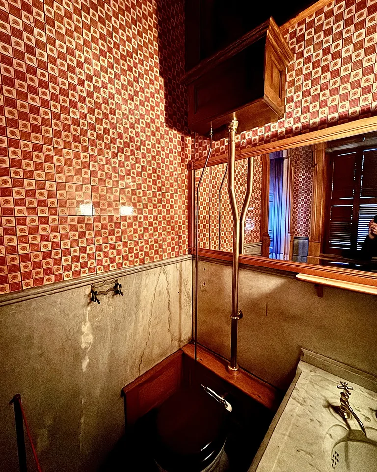 12 Green and Black Bathroom Ideas That Look Expensive, Not Dark 14 Brass mirror and sconces warming a green and black bathroom
