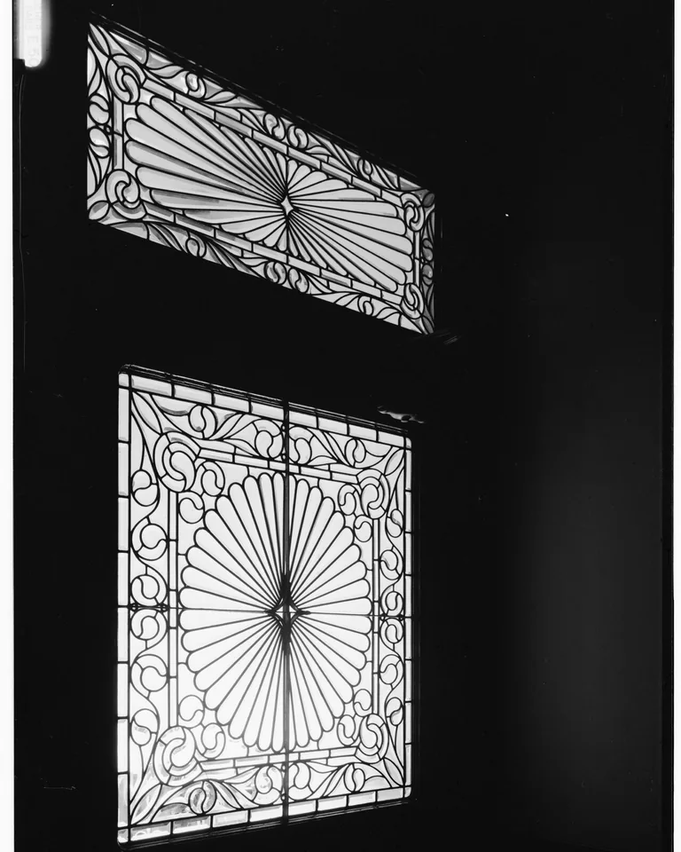 Stained glass transom window above a front door entryway