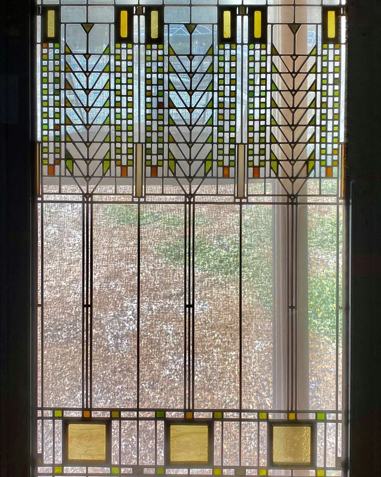 Prairie style geometric stained glass window with amber accents