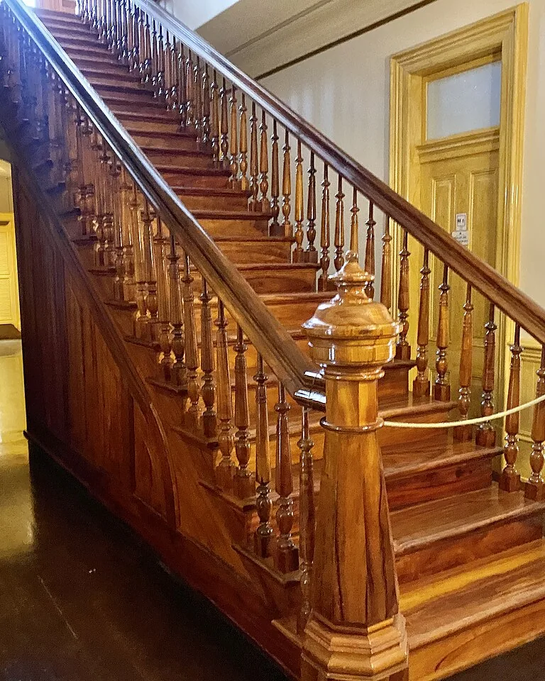 Wood paneled staircase wall in a modern entryway