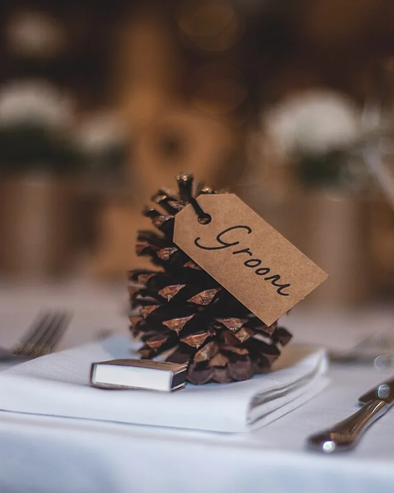 Close-up of an autumn table setting with pumpkins and amber glassware